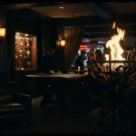 A bright flame rises from a metal brazier beside a dark gaming lounge with a softly lit roulette table and trophy shelf