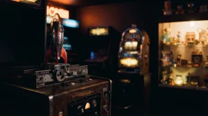 A small rocket poised on a launch track in a warm neon arcade, with a softly lit slot machine in the background