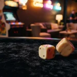 A pair of polished dice on a dark velvet gaming table, with a softly glowing arcade cabinet in the background.