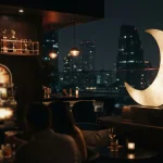 A luminous crescent moon sculpture in a dark rooftop lounge, with a softly glowing slot machine in the background