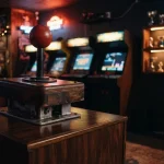 Oversized vintage arcade joystick beside glowing cabinets and a trophy shelf in a dramatic neon-lit gaming lounge